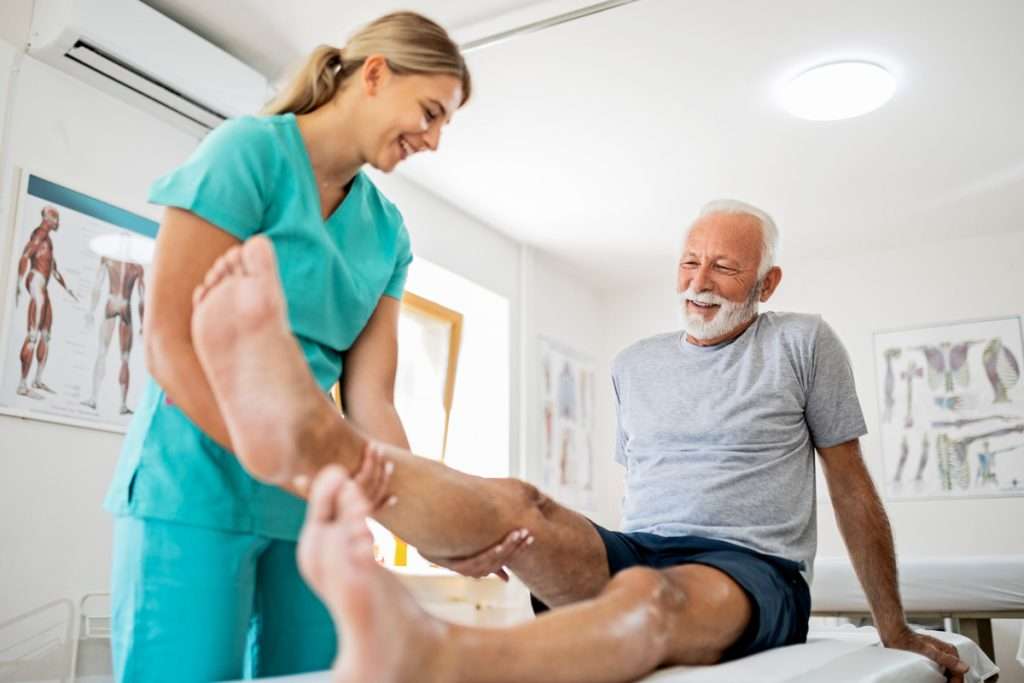 Physical Therapist assisting patient